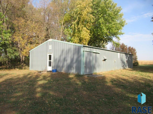 view of outbuilding with a lawn