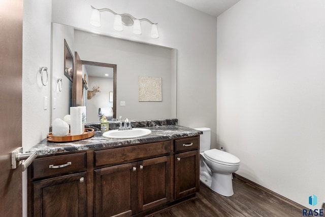 bathroom with vanity, wood-type flooring, and toilet