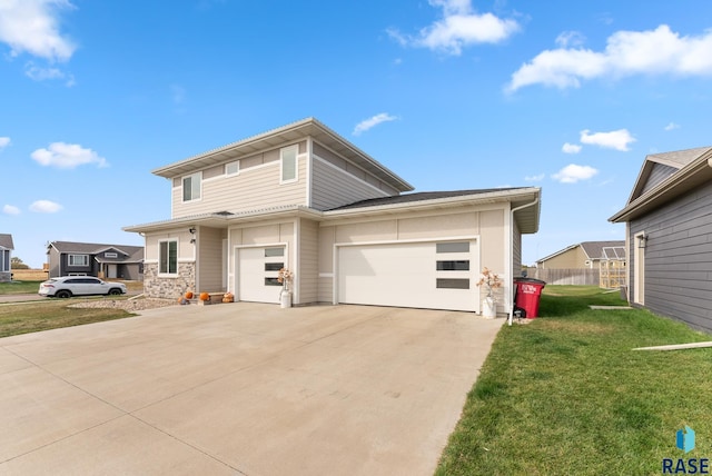 view of front of property with a front yard and a garage