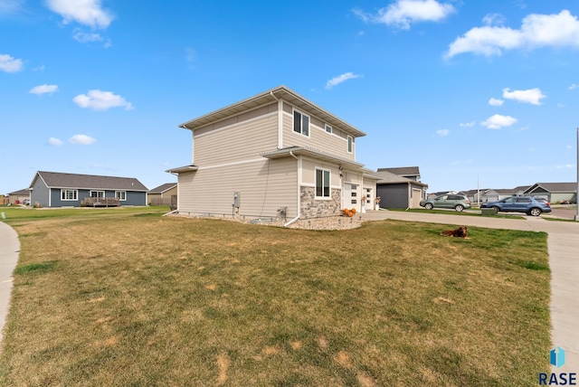 view of side of home with a yard and a garage