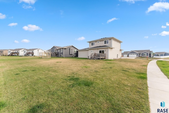 view of yard with a deck and a garage