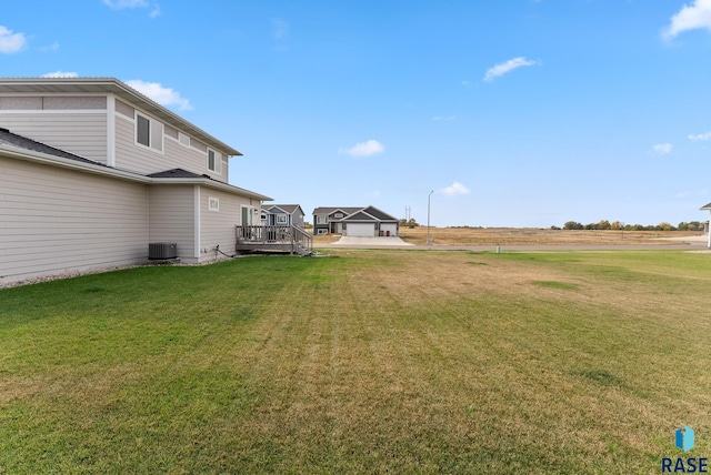 view of yard featuring a wooden deck and central AC unit