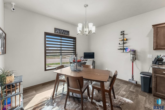 dining space with a notable chandelier and dark hardwood / wood-style floors