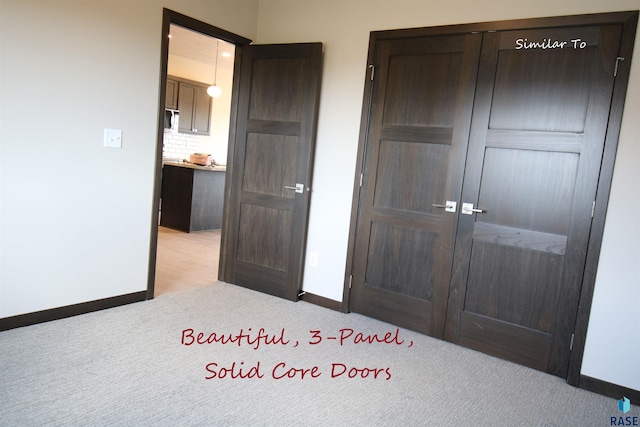 unfurnished bedroom featuring a closet and light colored carpet