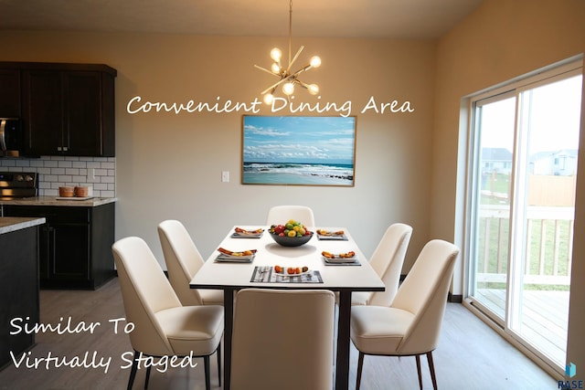 dining space featuring a notable chandelier and light hardwood / wood-style floors