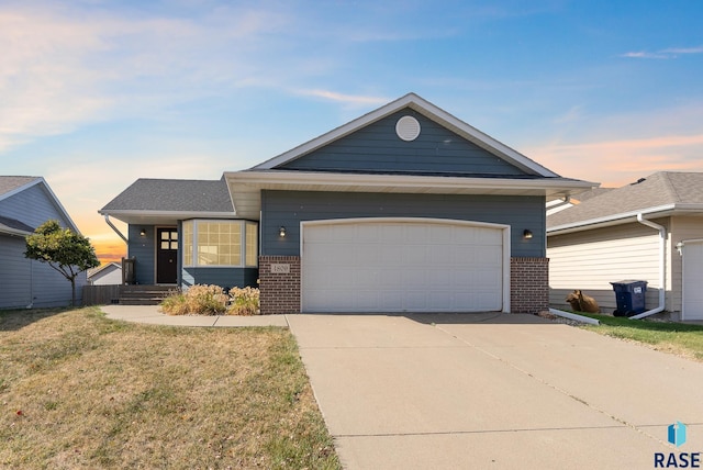 view of front of house with a lawn and a garage