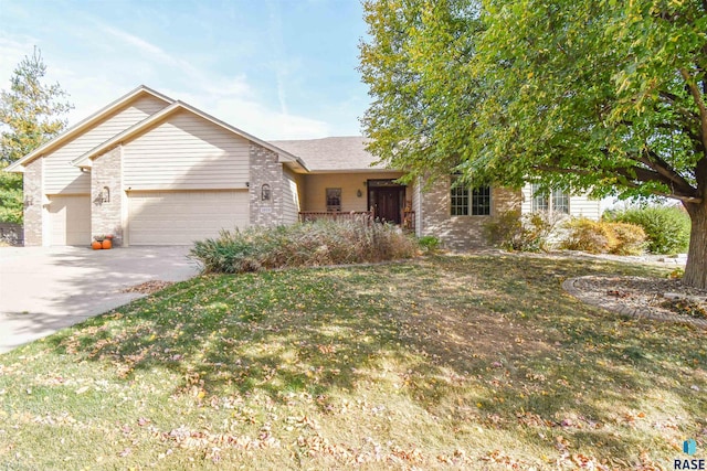 view of front of property with a front yard and a garage