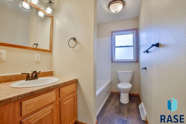 bathroom with vanity, toilet, and hardwood / wood-style floors