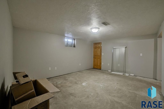 basement featuring a textured ceiling