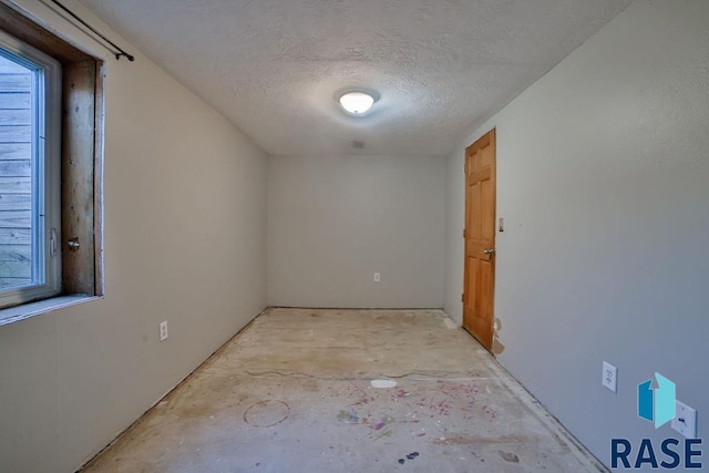 spare room featuring a textured ceiling