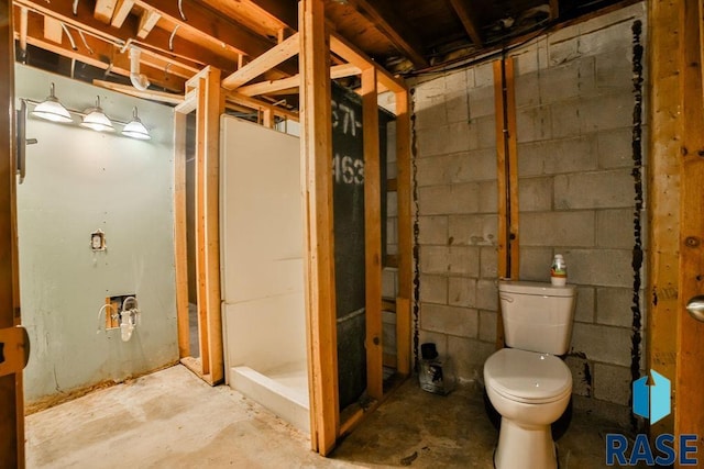 bathroom with concrete floors and toilet