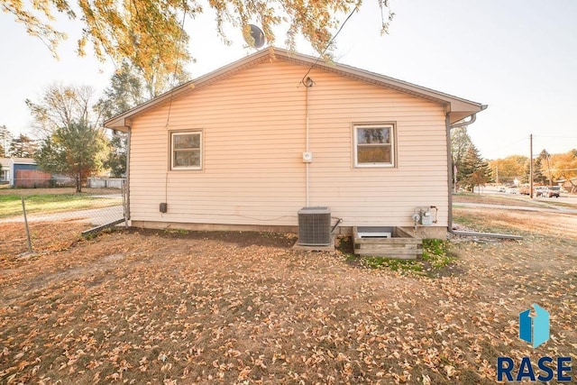 view of side of home with central AC unit