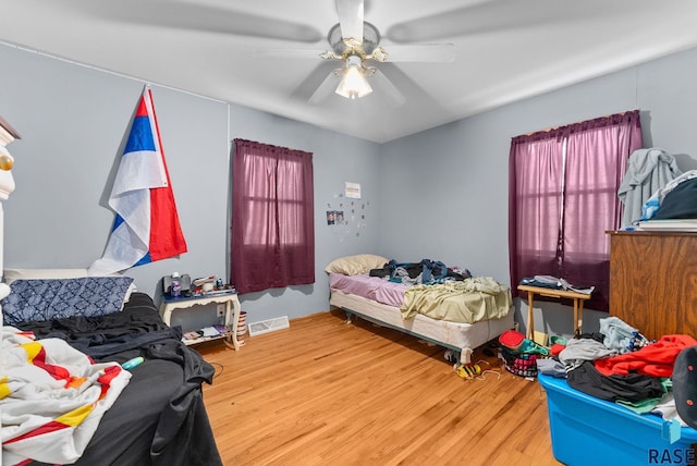 bedroom with hardwood / wood-style floors and ceiling fan