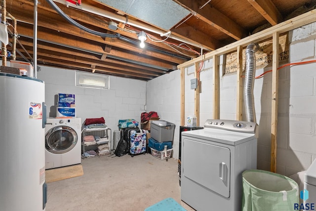 washroom with water heater and washing machine and clothes dryer