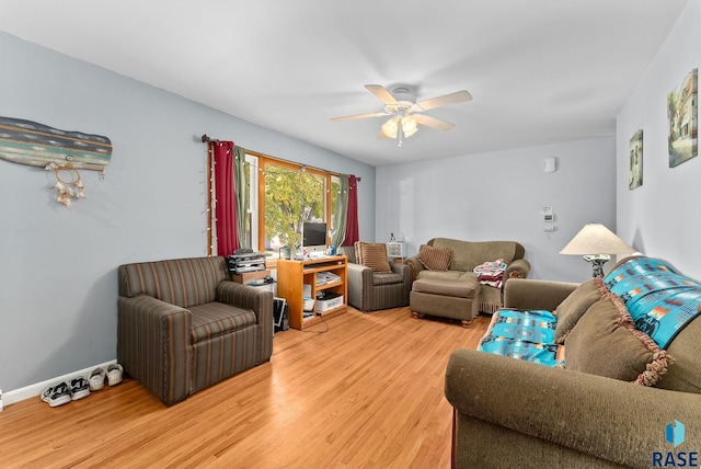 living room with ceiling fan and hardwood / wood-style flooring