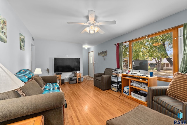 living room with hardwood / wood-style flooring and ceiling fan