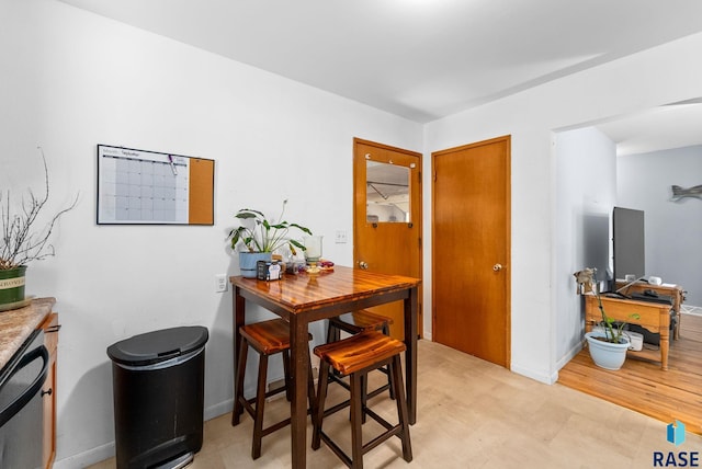 dining space with light hardwood / wood-style floors