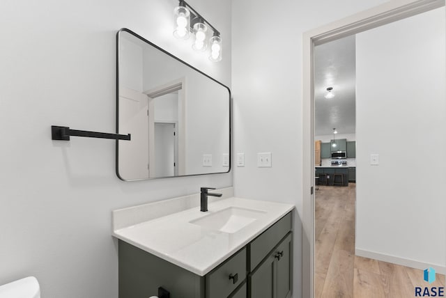 bathroom featuring vanity and wood-type flooring