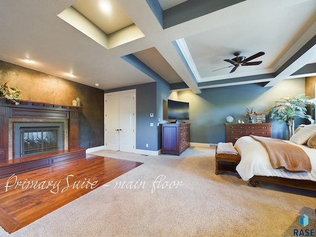 bedroom with light carpet, ceiling fan, beamed ceiling, crown molding, and coffered ceiling