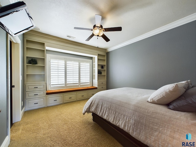 carpeted bedroom with ceiling fan and crown molding