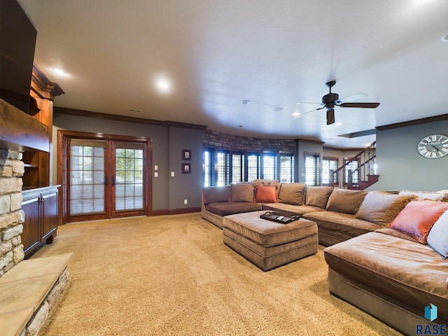 living room with ornamental molding, french doors, light carpet, and ceiling fan