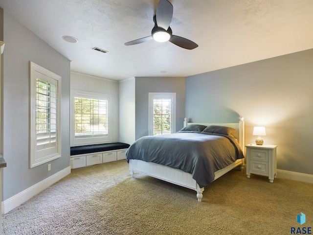 carpeted bedroom with a textured ceiling and ceiling fan