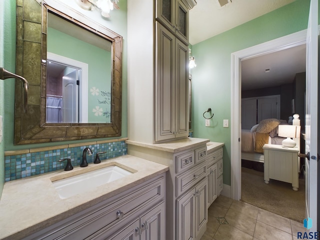 bathroom with vanity, decorative backsplash, and tile patterned flooring