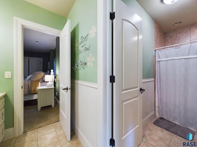 bathroom featuring vanity, a shower with curtain, and tile patterned flooring