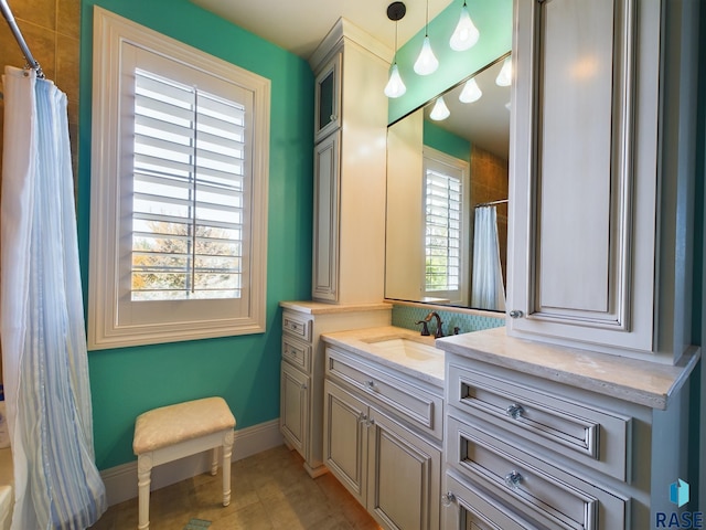 bathroom with vanity, walk in shower, and tile patterned flooring