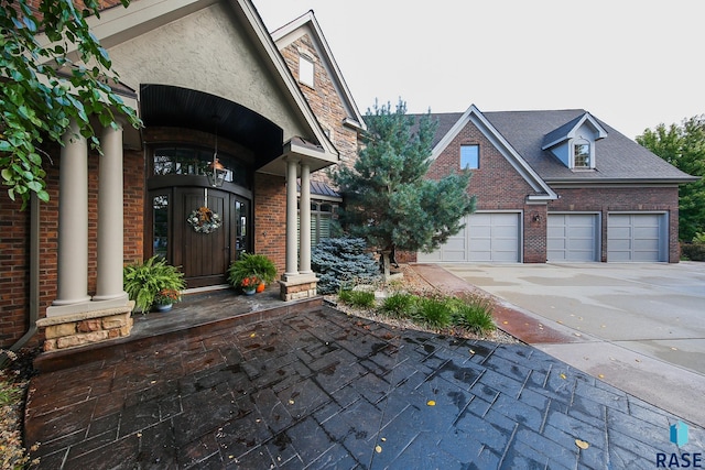 view of exterior entry with a garage