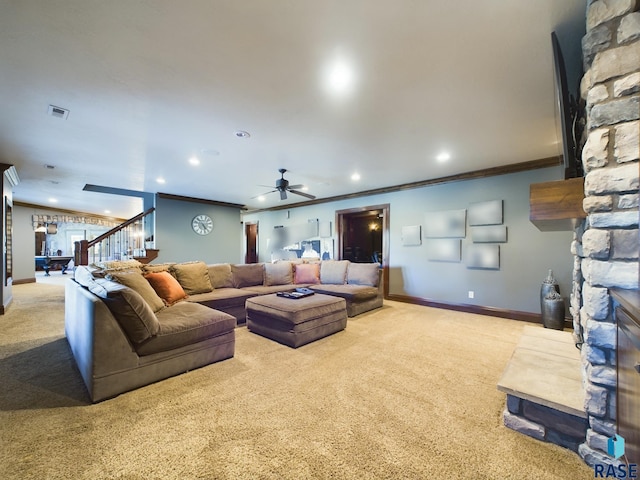 living room with ornamental molding, light colored carpet, and ceiling fan