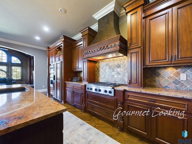 kitchen featuring custom exhaust hood, decorative backsplash, ornamental molding, sink, and stainless steel appliances