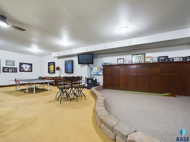 playroom with ceiling fan and carpet