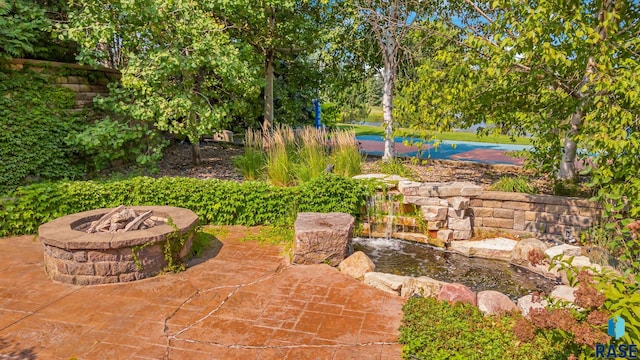 view of patio with a fire pit