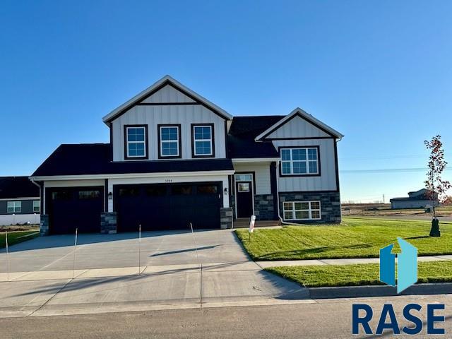 craftsman-style home with a front lawn and a garage