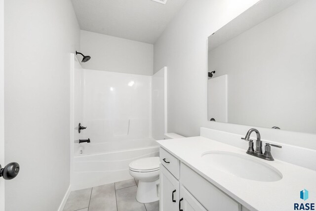 full bathroom featuring toilet, vanity, tile patterned floors, and washtub / shower combination