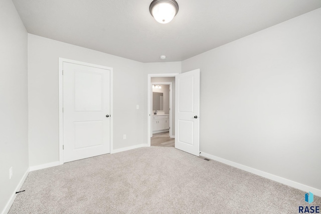 unfurnished bedroom featuring light colored carpet