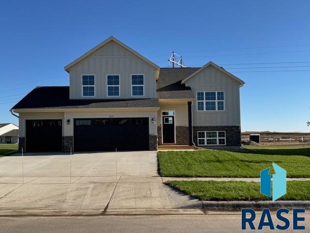 view of front of home with a front yard and a garage