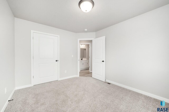 unfurnished bedroom with light colored carpet