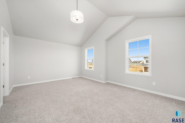 interior space with carpet floors and vaulted ceiling