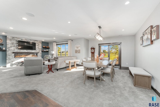 carpeted dining space with a fireplace