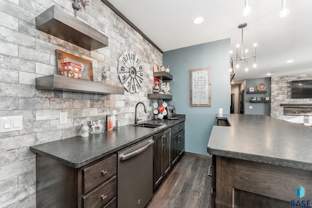 kitchen with dishwasher, dark hardwood / wood-style floors, dark brown cabinets, sink, and pendant lighting