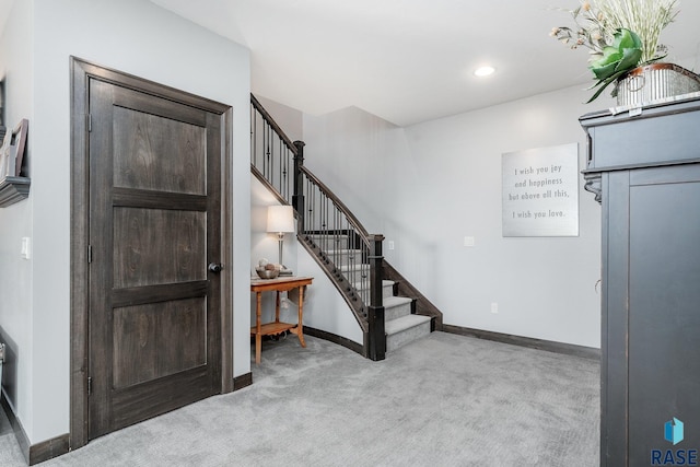 view of carpeted foyer entrance