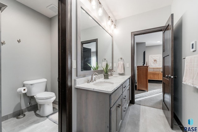 bathroom with toilet and vanity