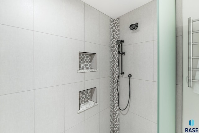 bathroom with tiled shower