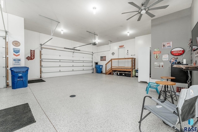 garage featuring a garage door opener and ceiling fan