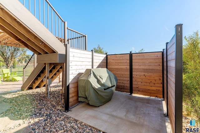 view of patio with a deck and a grill