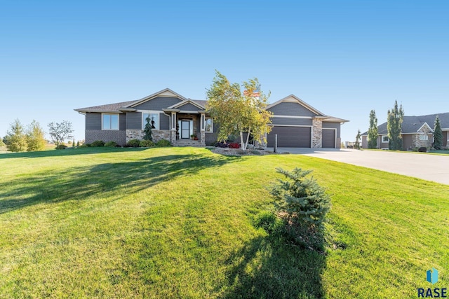 view of front of house with a front yard and a garage