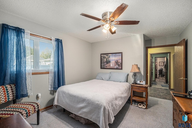 bedroom featuring a textured ceiling, carpet flooring, and ceiling fan