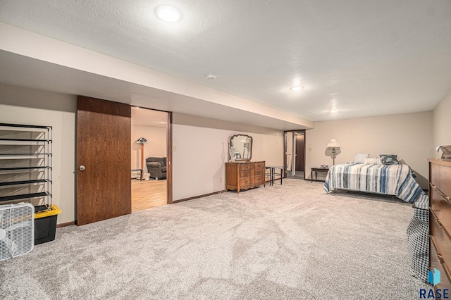 bedroom featuring a textured ceiling and carpet floors